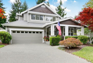 grey house with covered porch and garage